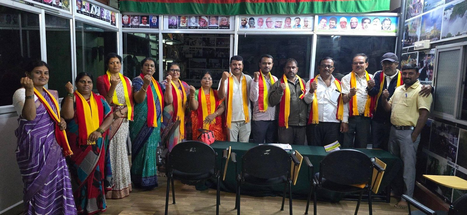 Members gathered in the Parishat hall beneath portraits of Kannada icons