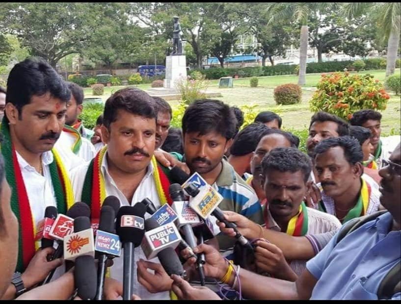 Narayan S addressing the press surrounded by members